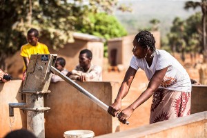 Woman pumping water in Burkina Faso