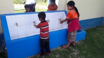 Kids washing their hands in a facility in Quiché, Guatemala