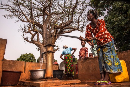Woman pumping water in Burkina Faso