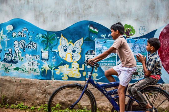 two boys riding a bicycle