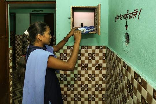young indian woman taking a sanitary pad