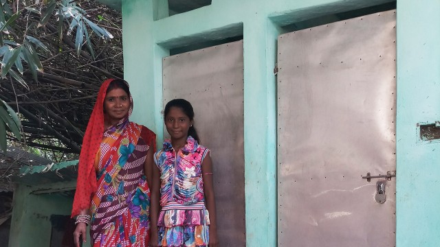 Khushbu and her mother in front of the IHHL constructed in their house.