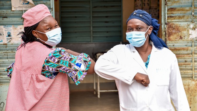 Women greeting each other with the elbow in Burkina Faso