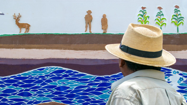 man looking at a mosaic