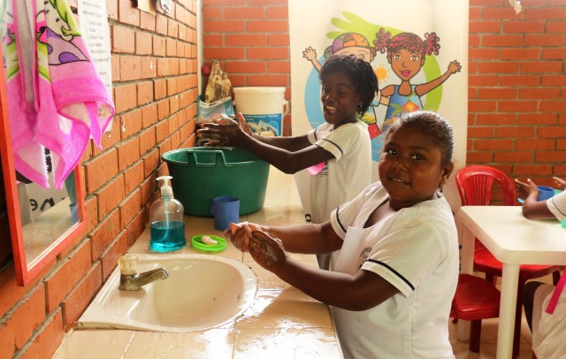 girls washing their hands