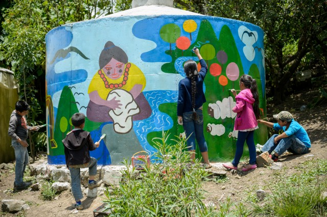 Kids painting a mural in Mexico