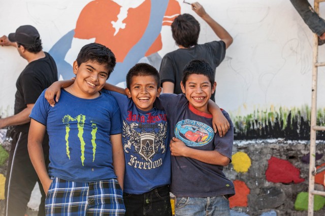 three boys posing for the camera in Central America