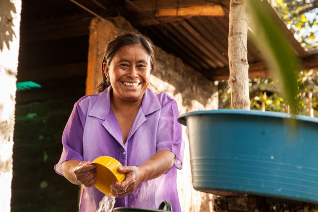 Woman washing dishes in Guatemala