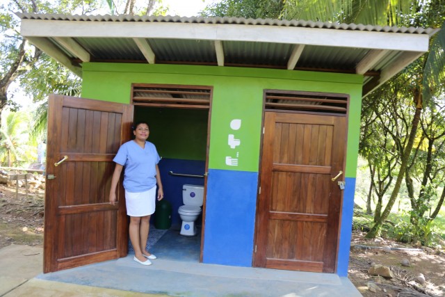 Robin Cris Centeno Castro, a nurse at San Pablo Health Center in Tasba Pri, Nicaragua, stands in front of the clinic's new bathrooms. (Photo: WaterAid - Eduardo Rodriguez)