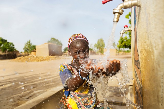 Girl smiling and washing her hands on the Ji Ni Beseya Project